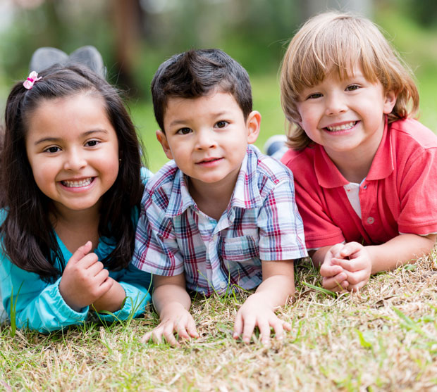 kids smiling in grass